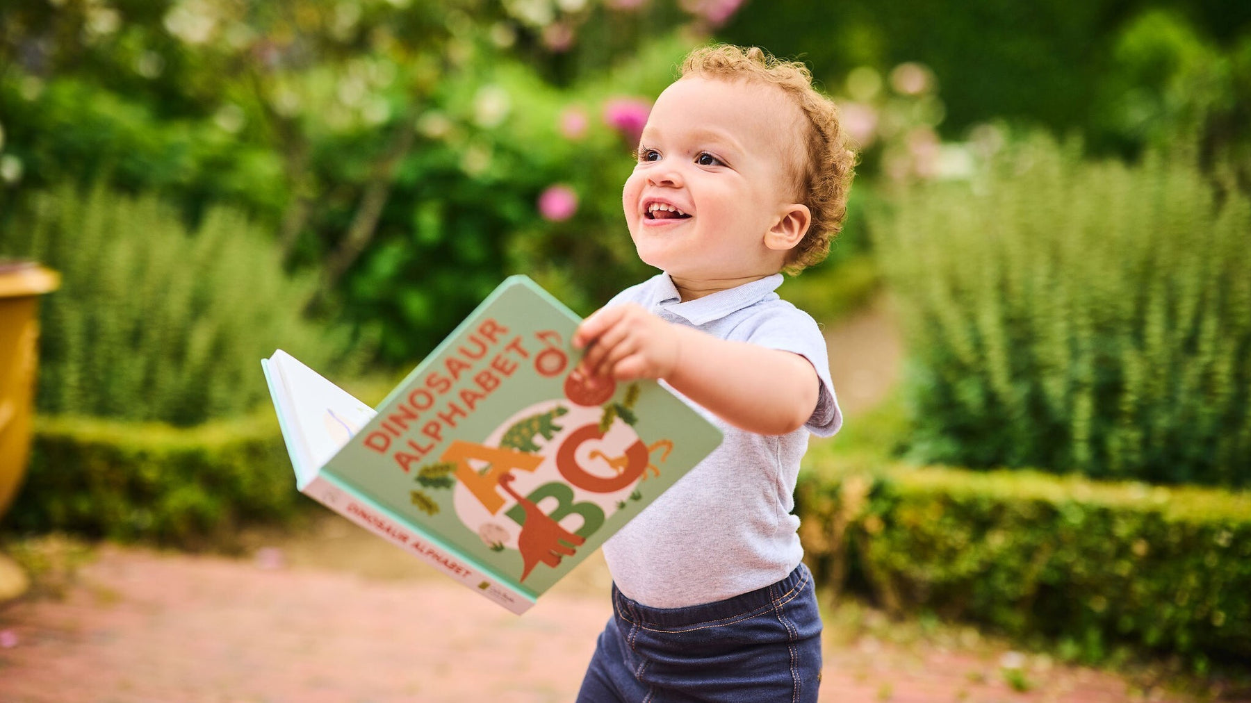 A baby is reading a book. Fun toddler educational activity