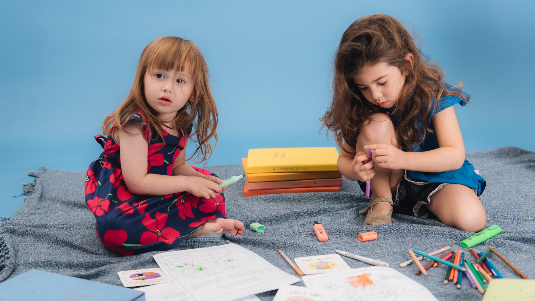 Two toddler girls are drawing with colorful pens. Toddlers fun activities, sensory play, educational.