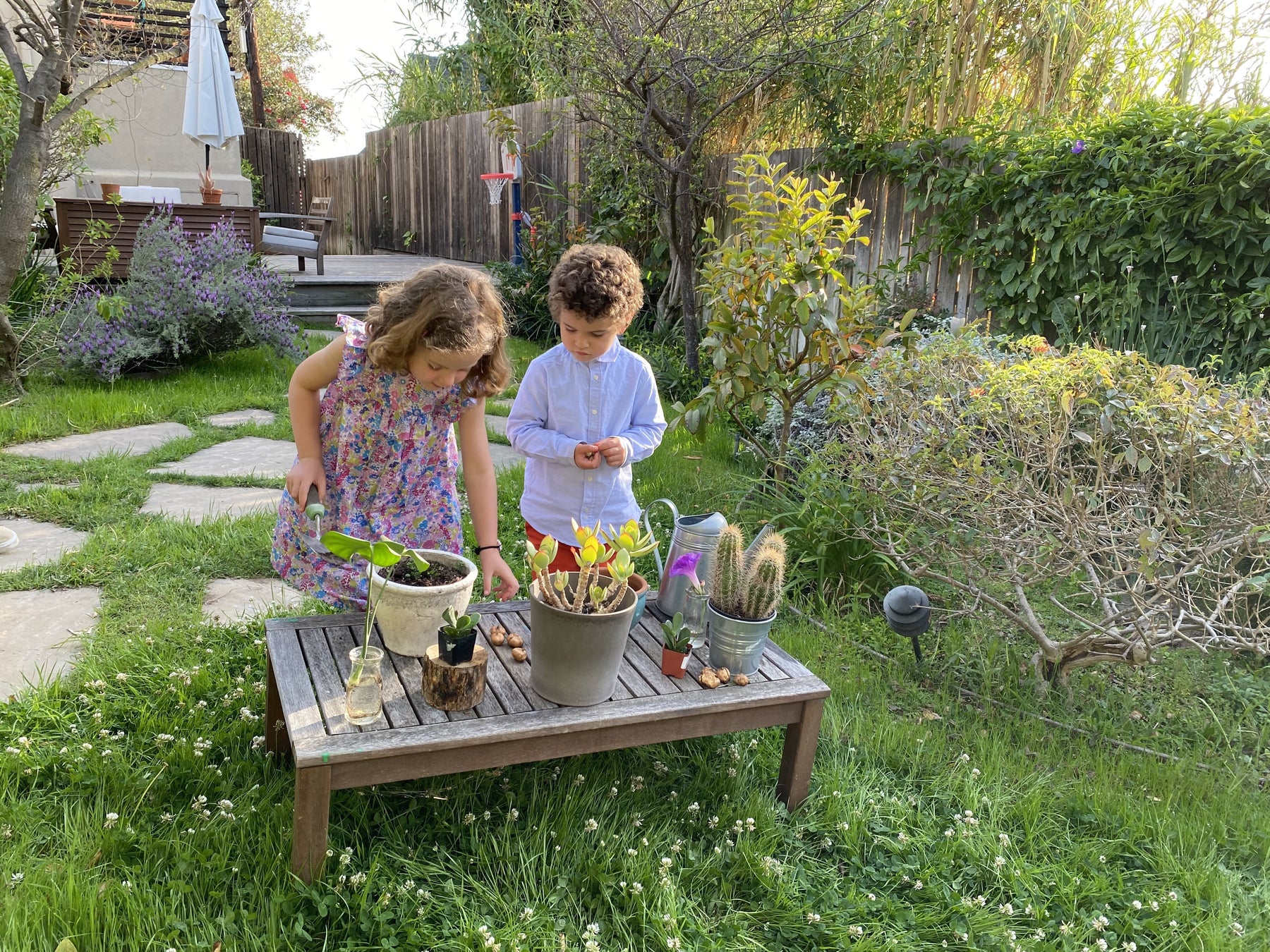 2 children planting flowers in honor of earth day