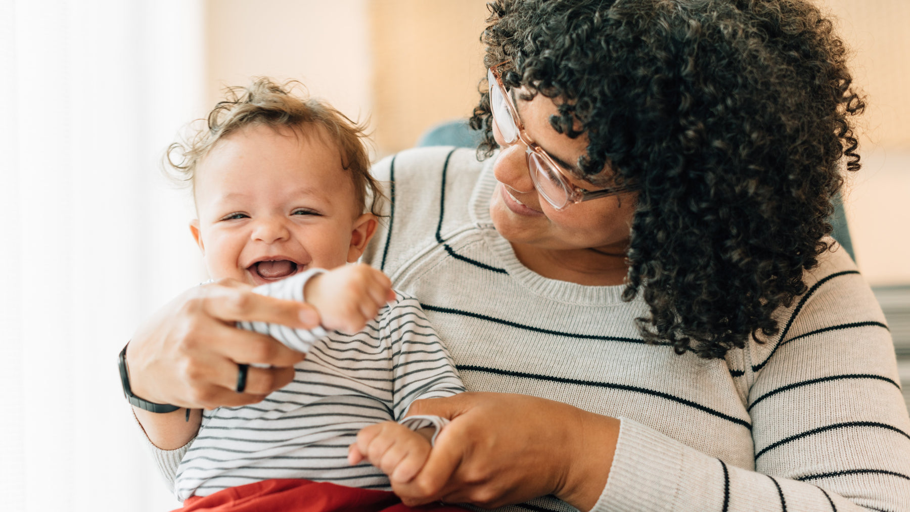 A Mom is playing with her toddler. Kids education, culture, heritage, Kwanzaa.