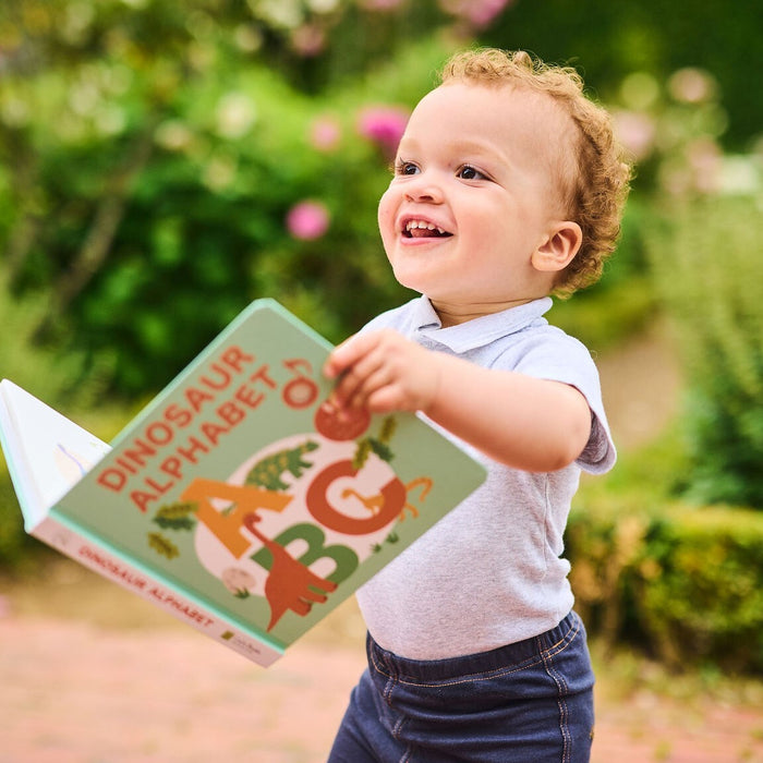 A baby is reading a book. Fun toddler educational activity