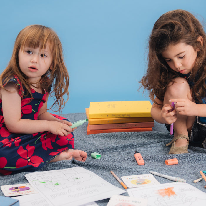 Two toddler girls are drawing with colorful pens. Toddlers fun activities, sensory play, educational.