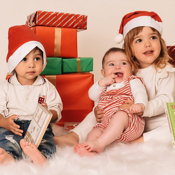 Three kids are posing with Christmas gifts. Fun, educational Christmas gift for kids.