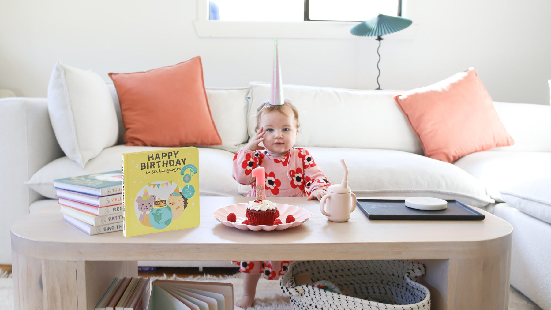 A baby is celebrating her first birthday with a cake. Toddler birthday parties ideas.