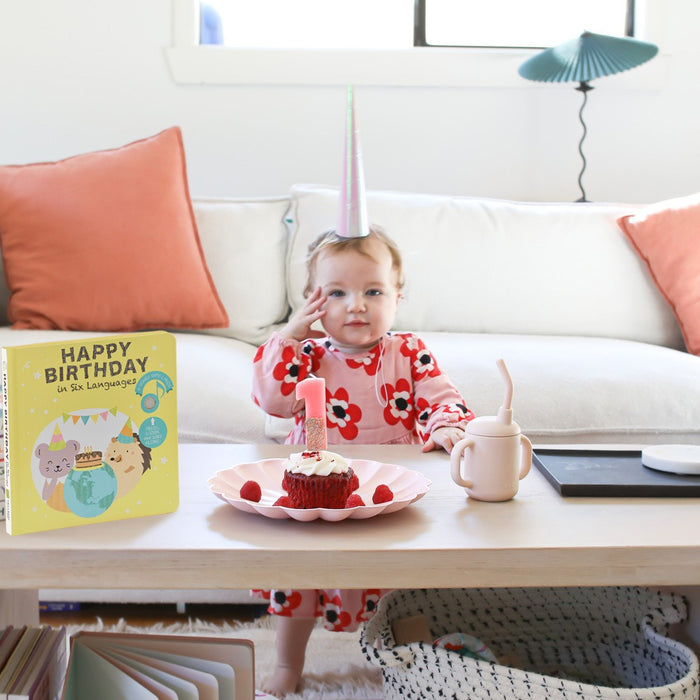 A baby is celebrating her first birthday with a cake. Toddler birthday parties ideas.