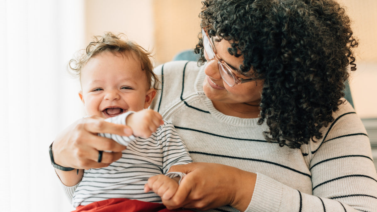A Mom is playing with her toddler. Kids education, culture, heritage, Kwanzaa.