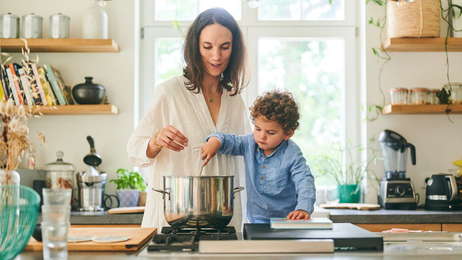 A Mom is cooking with her son. Parenting kids, family activity