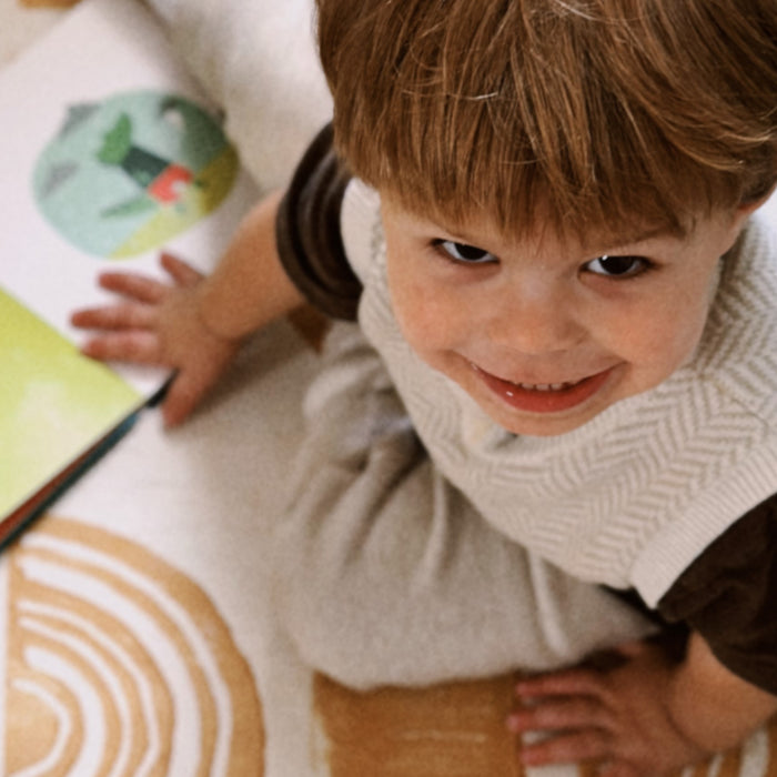 Close up of a boy looking up and smiling. Kids, educational strategies, fun activities.