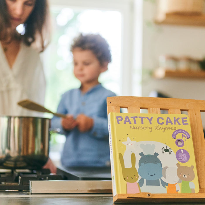 A Mom is reading and cooking with her young son. Children books, fun activities, educational.