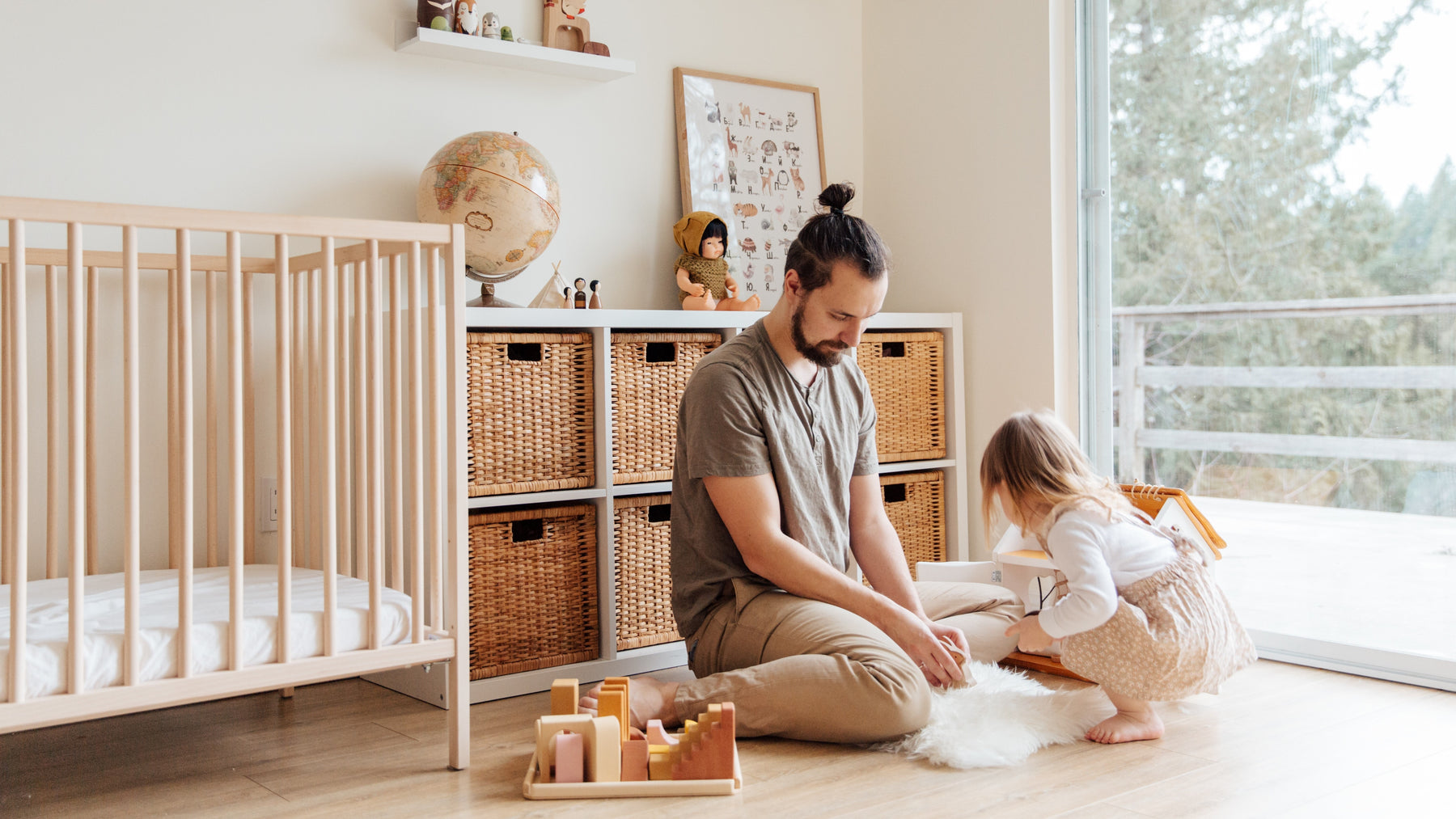 A Dad and his daughter are playing with a rug. Kids education activity, montessori parenting.