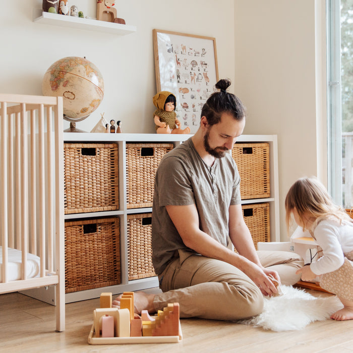 A Dad and his daughter are playing with a rug. Kids education activity, montessori parenting.